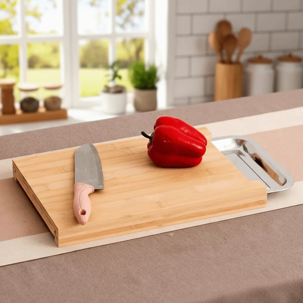Beech wood cutting board with a knife and red pepper on a kitchen counter