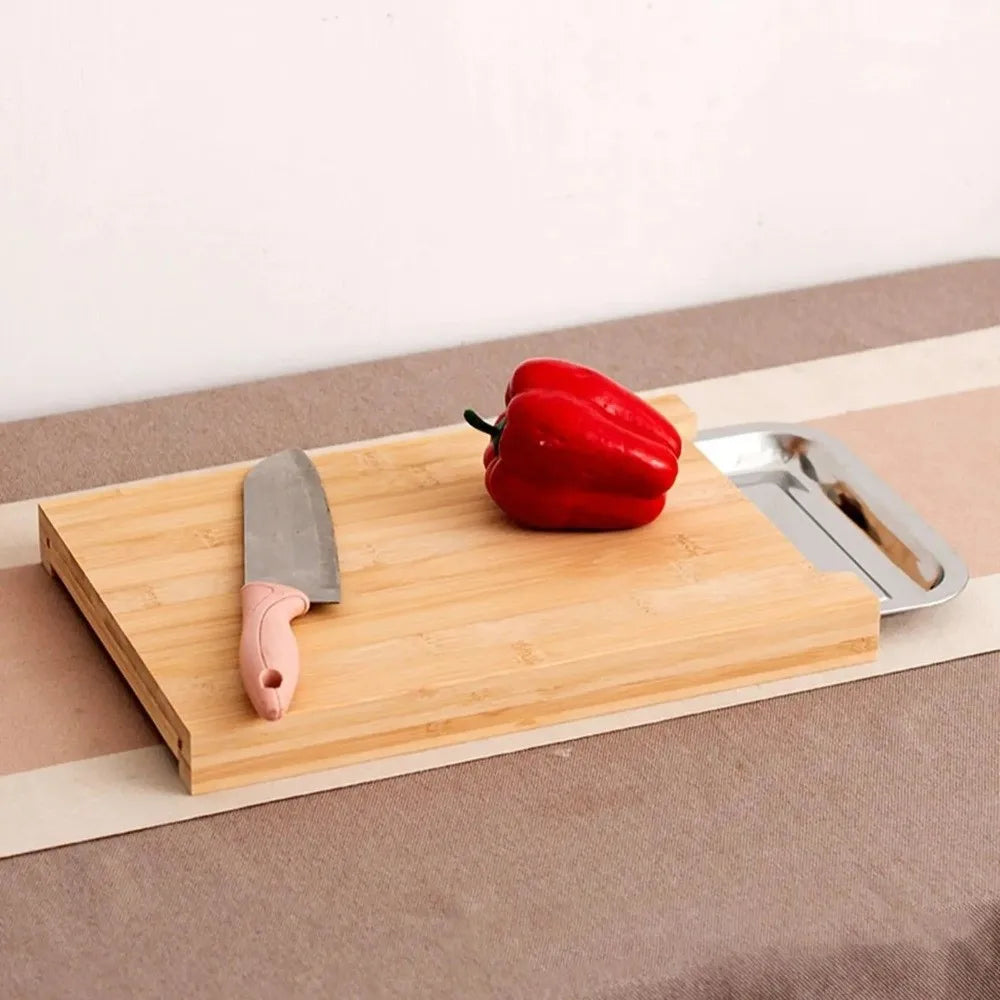 Beech wood cutting board with a knife and red pepper on a neutral background