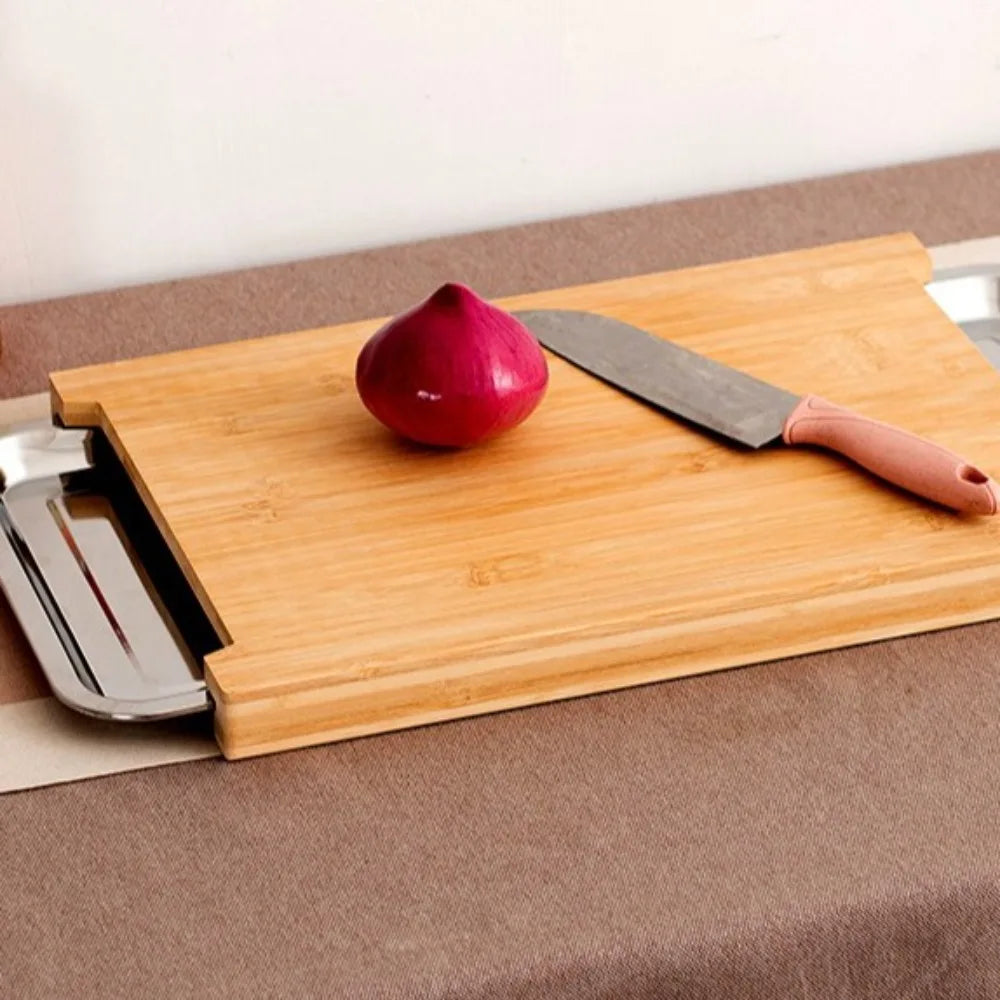 Beech wood cutting board with built-in trays on a countertop with a knife and red onion on top