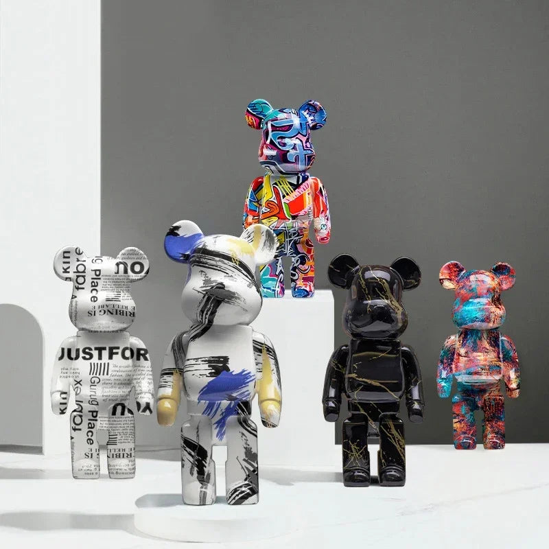 Collection of colorful and patterned graffiti bear figurines on a gray background