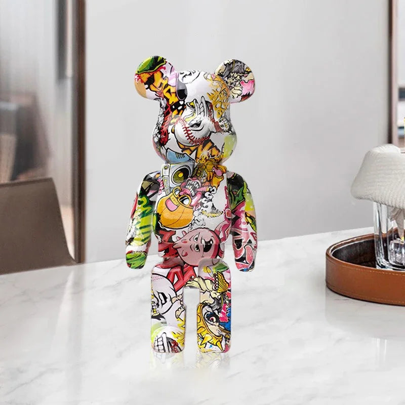 Colorful graffiti bear figurine on a white surface with a neutral background