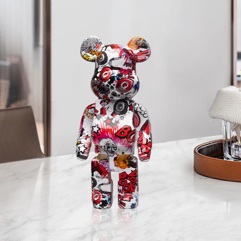 Colorful, patterned graffiti bear figurine on a white surface with a neutral background