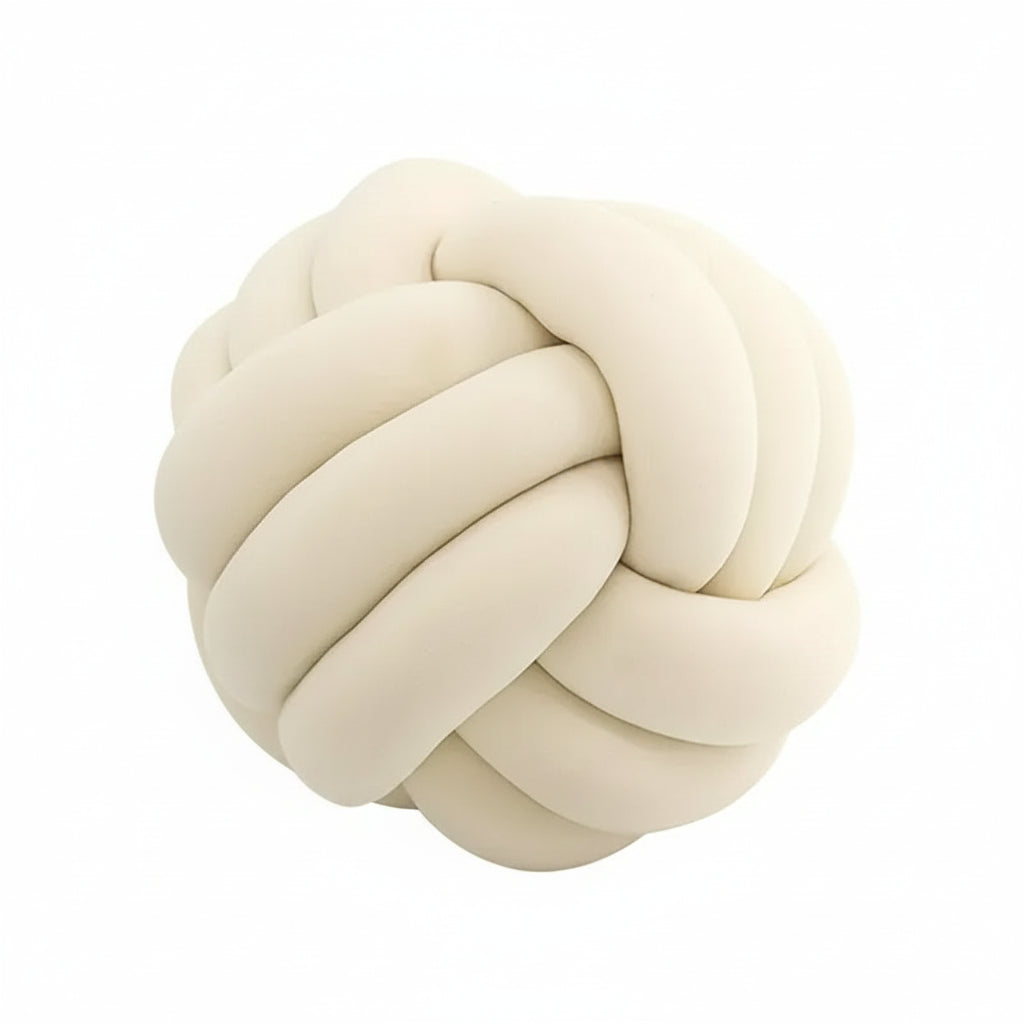 Cream-colored knot-shaped pillow on a white background
