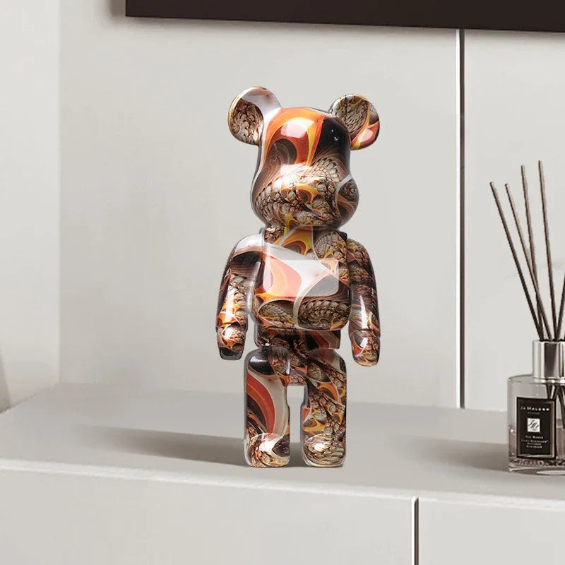 Decorative graffiti bear figurine with marbled pattern on a shelf next to a diffuser.