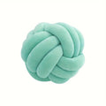 Light green knot-shaped pillow on a white background