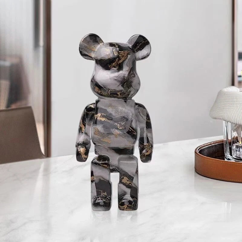 Marble-patterned graffiti bear figurine on a white surface with a blurred background