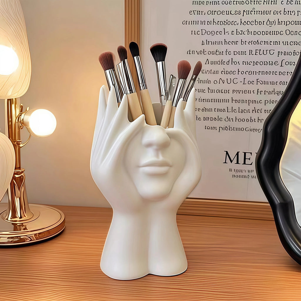 Nordic Human Body Sculpture Desk Organizer with makeup brushes on a wooden surface.