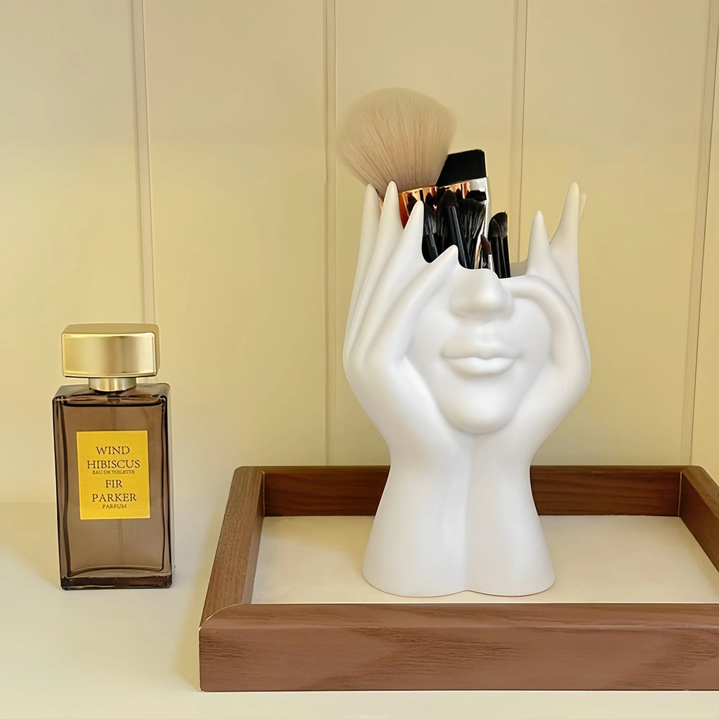 Nordic Human Body Sculpture Desk Organizer with makeup items on a wooden tray next to a perfume bottle.