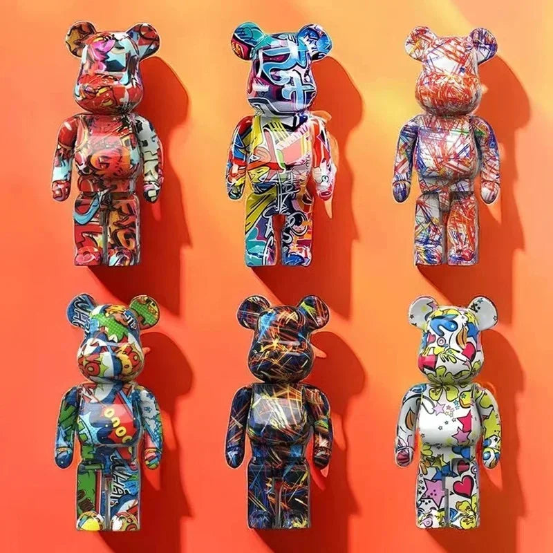 Six colorful, patterned graffiti bear figurines on an orange background