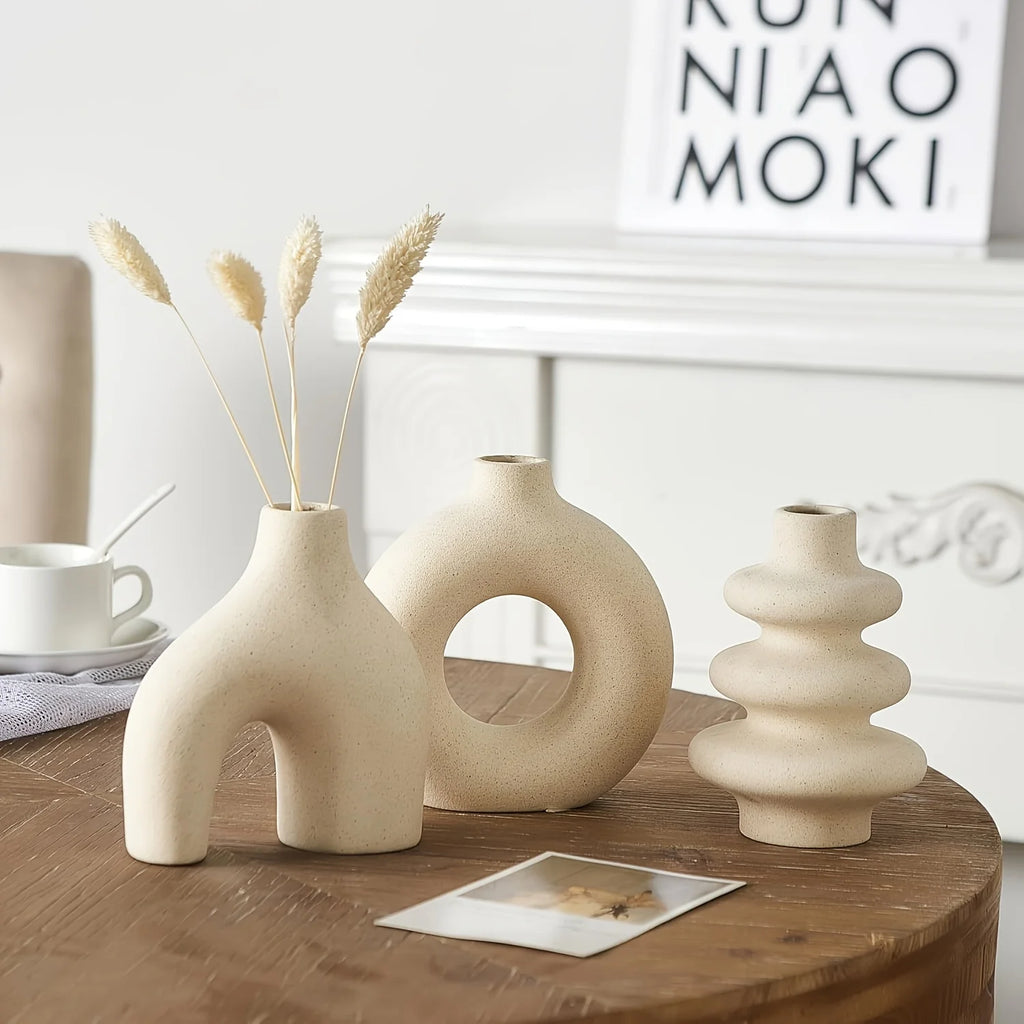 Three light yellow Boho Ceramic Vases on a wooden table with a neutral background