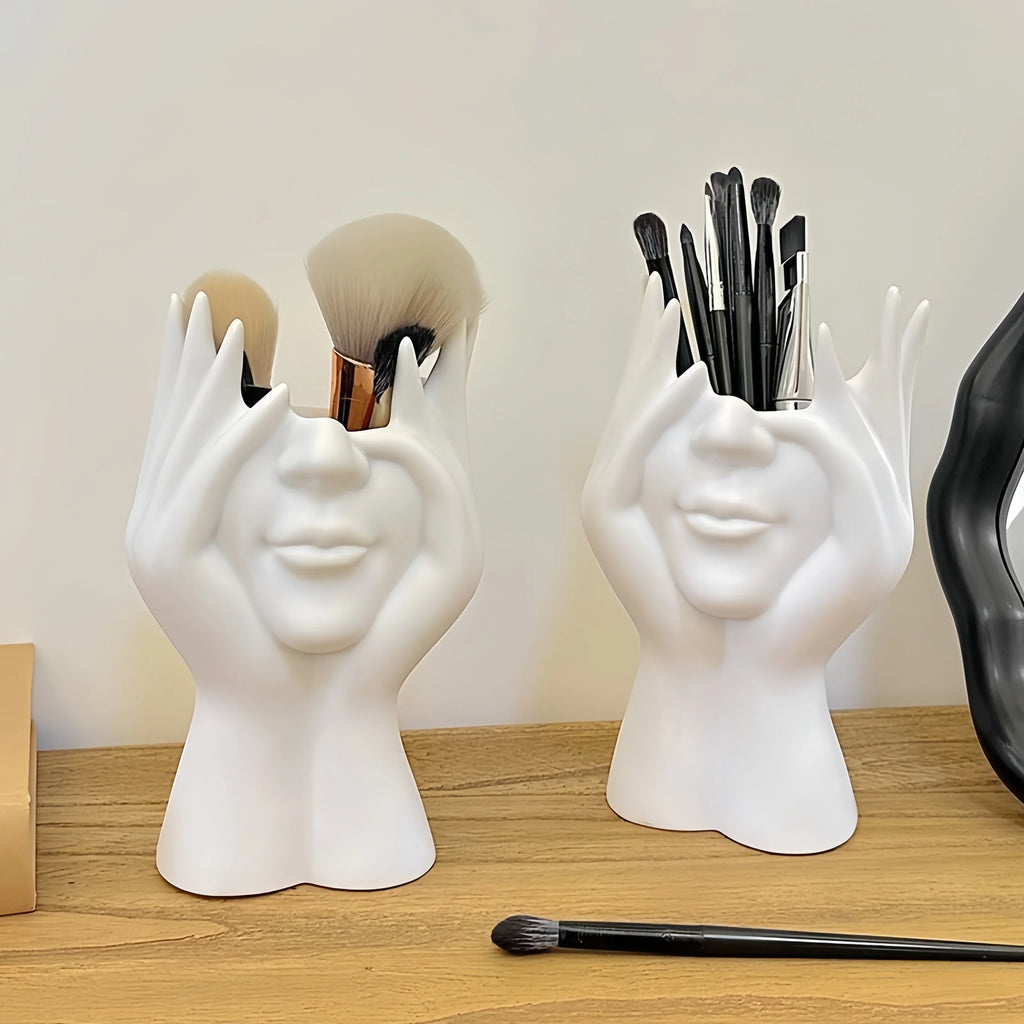 Two Nordic Human Body Sculpture Desk Organizers with makeup brushes on a wooden surface.