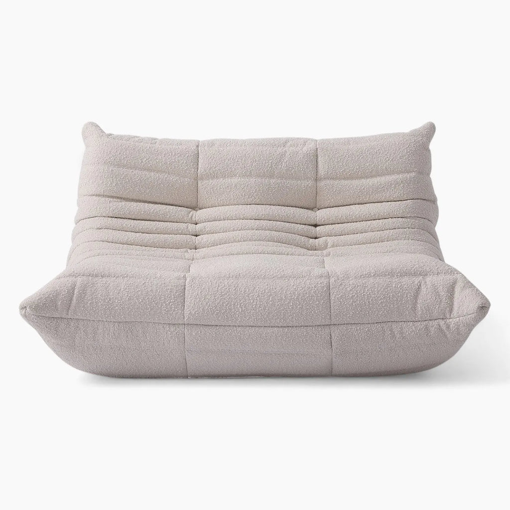 Two seater Rice Amb Velvet Caterpillar Lazy Sofa with a quilted design on a white background