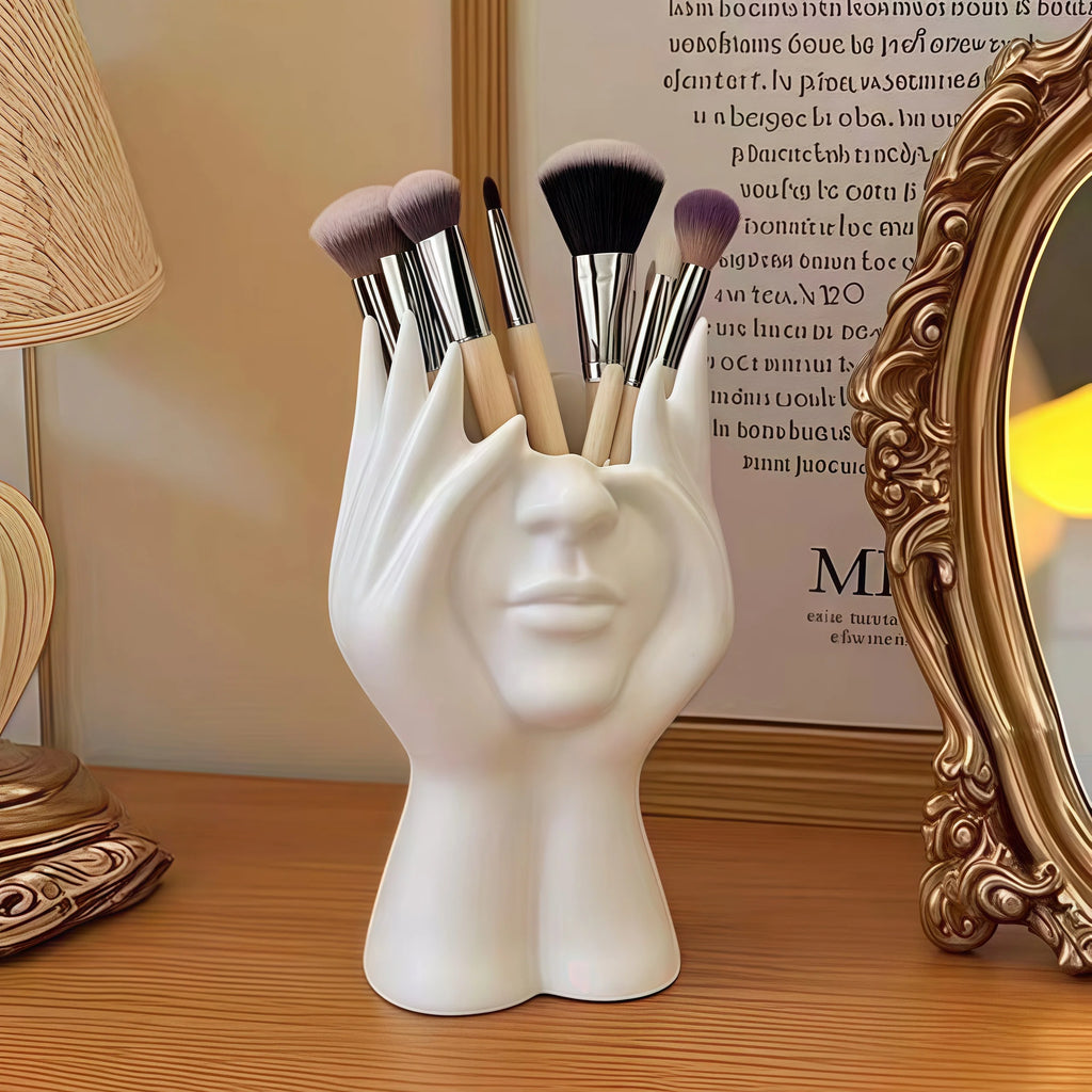 White Nordic Human Body Sculpture Desk Organizer with makeup brushes on a wooden surface.